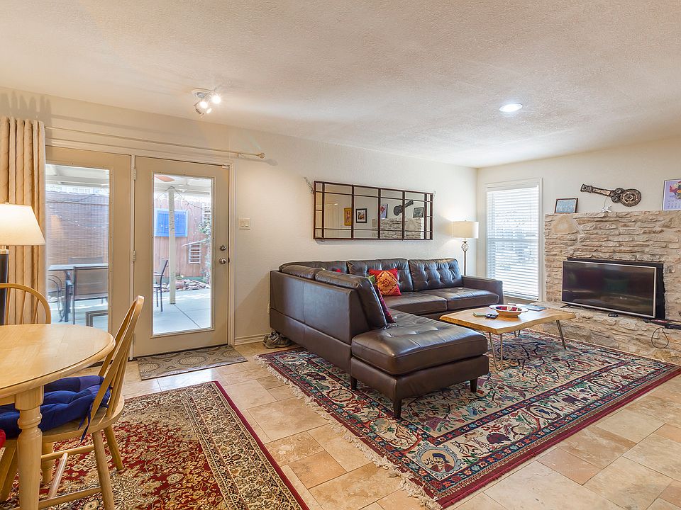 Living and dining area. Side door to covered porch. Not a working fireplace. All furnishings exactly as shown.