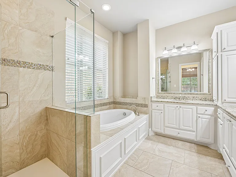 LOVE that this has a tub and a shower. Separate vanities and bright light.