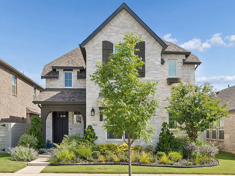Professionally landscaped front yard, maintenance included.