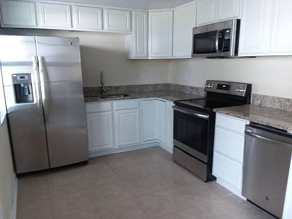 stainless kitchen appliances, plenty of storage space and a spacious open kitchen