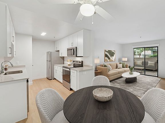 Renovated Package I kitchen, living, and dining area with hard surface flooring