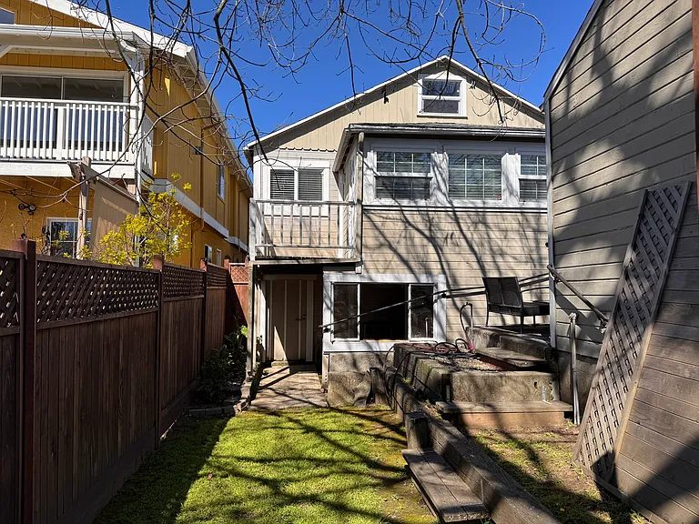 View from the back yard to the house. Office and deck on the first floor. Laundry room in the basement.