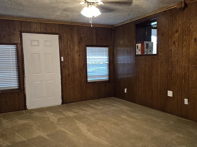 Second family room with built in entertainment center with book shelves and cabinets