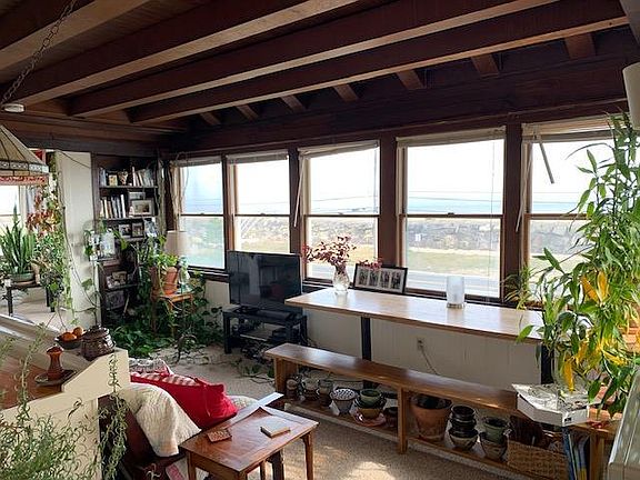 You can see the sea wall through the window and the ocean beyond.