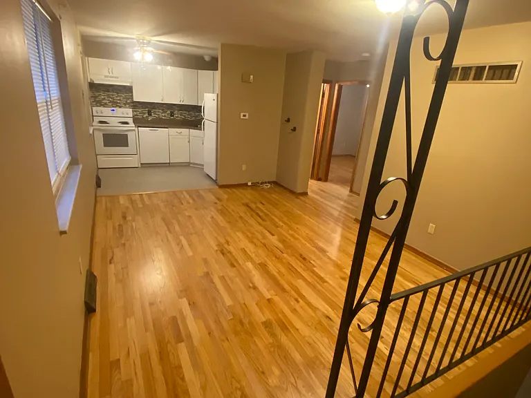 View of living room and kitchen with refurbished hardwood flooring!