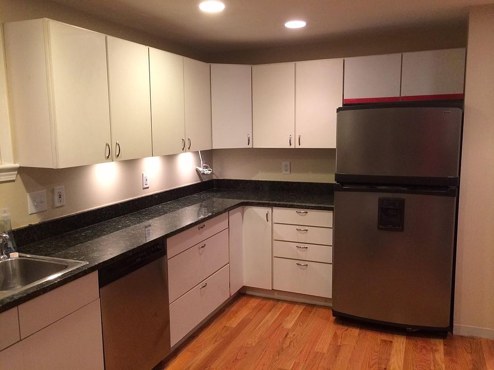 Large kitchen with granite countertops, stainless finishes, dishwasher and hardwood floors.