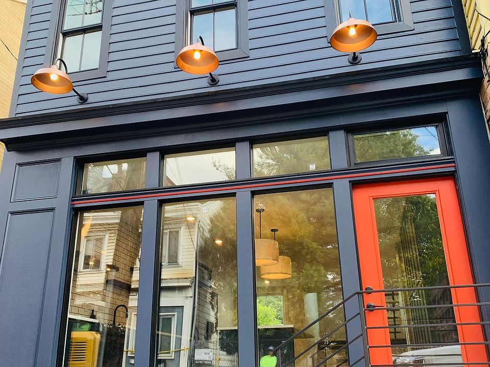 The newly renovated storefront offers sunlight to the interior and pays homage to the days when this building provided goods and services to local residents.
