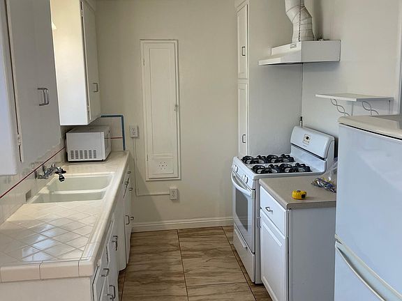 Kitchen with gas range and refrigerator.