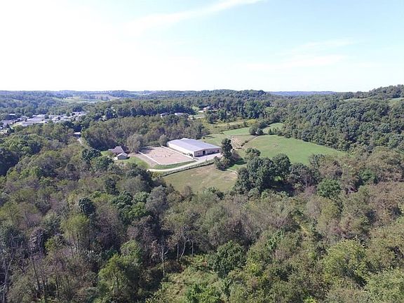 Country Living at it's BEST! 34+ Picturesque Acres offering an Established Horse Farm complete w/ 28 Stall Barn adjacent to 180x