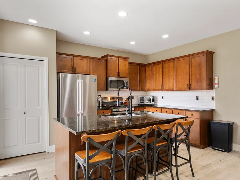 Island seats 4, French Door fridge, gas stove, micro hood and dishwasher along with various small appliances included: Keurig, countertop oven, rice cooker, water kettle, Crock Pot, Blender, along with bowls, plates, cups, cutlery, knives, etc.