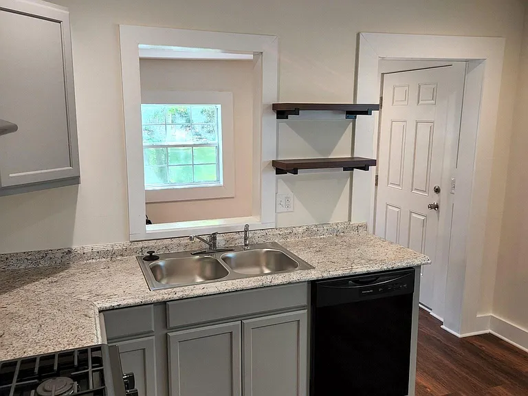 Kitchen new range, dishwasher, disposal. Back room separate laundry room with drop off area