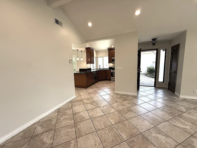 Dining room area showing kitchen and entry.