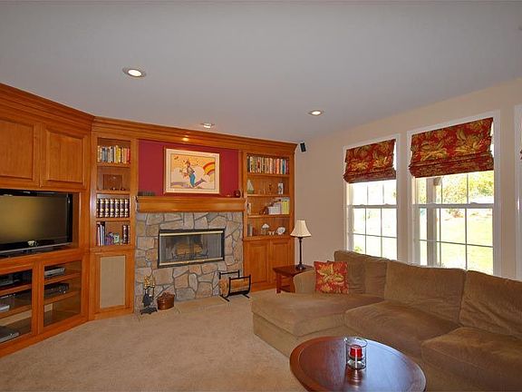 Large Family Room with Maple Buit-ins and River Rock Fireplace