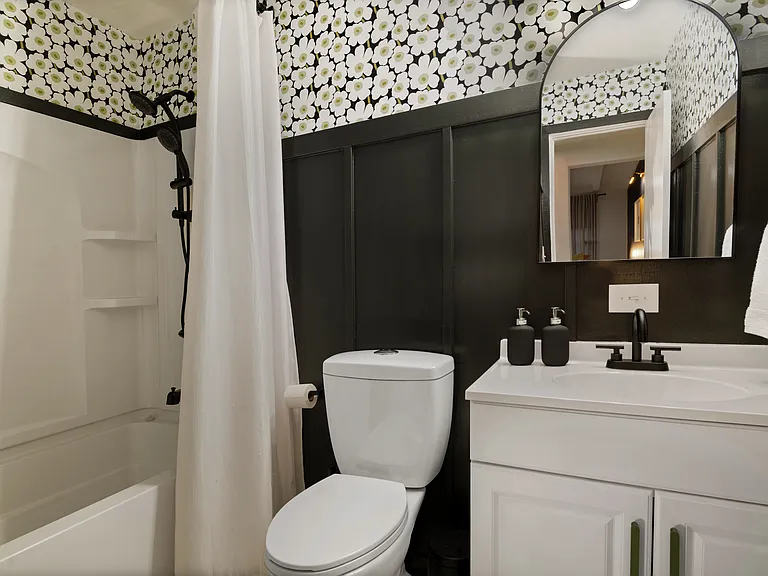 Hall Bath has both a shower and tub, loads of premium towels, in-shower toiletries dispensers, and blow dryer with diffuser.