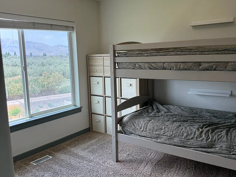 Bedroom 1 with walk in closet and Jordan River / Mountain views.