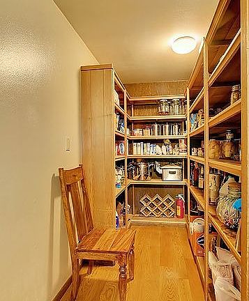 Huge walk-in pantry with built-in wood shelving!