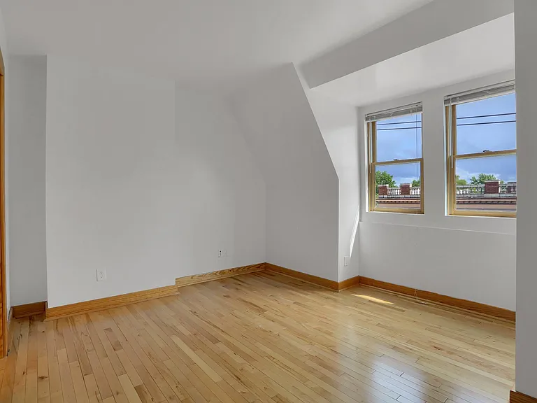 Front Bedroom Upper Floor - exposed brick wall, hardwood floor, ceiling fan, 10' ceilings, energy-efficient lighting