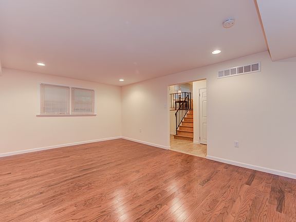 Huge lower level family rm features new hardwoods