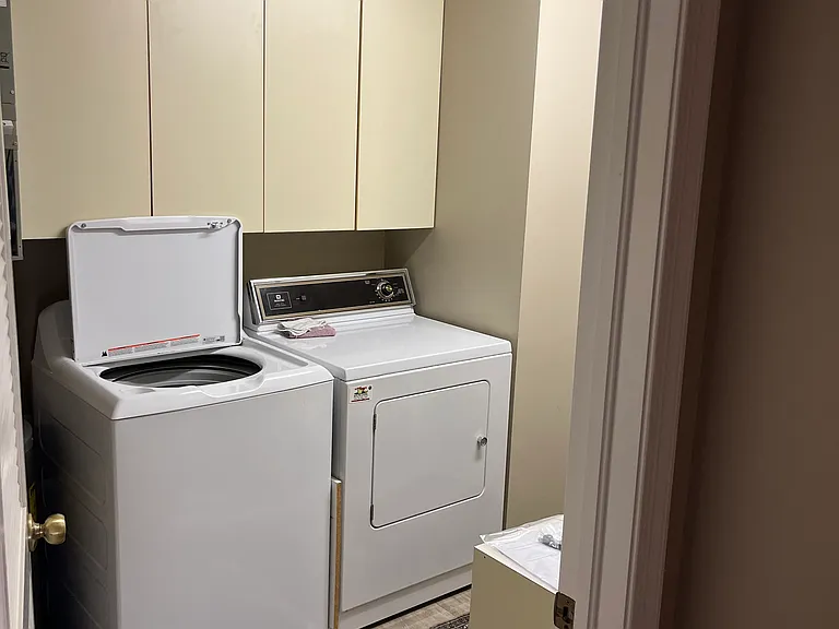 Large laundry room with en suite washer, dryer and plenty of storage.