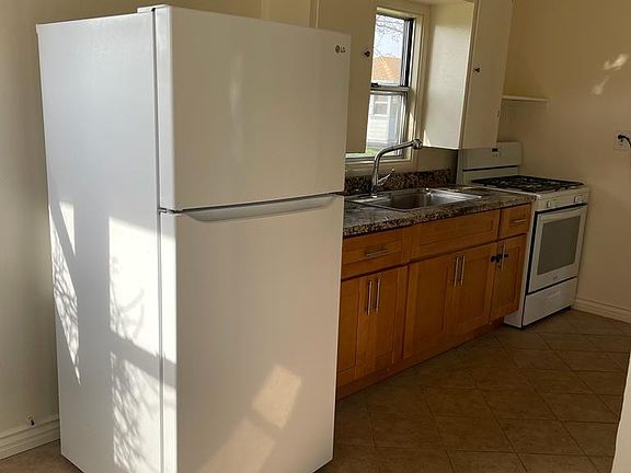 Kitchen with granite countertop and gas stove
