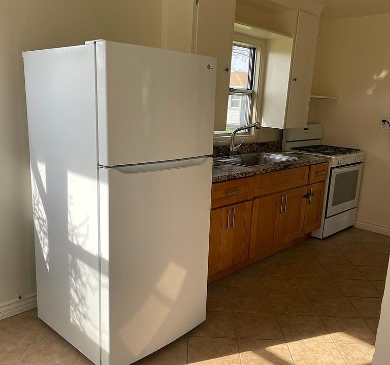 Kitchen with granite countertop and gas stove