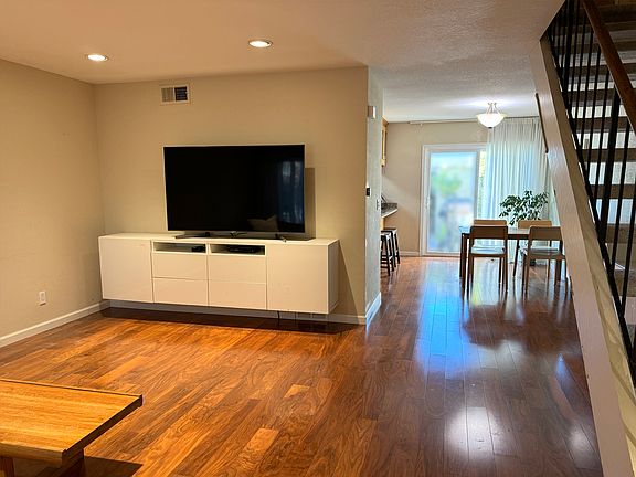 TV and other furniture not included. White floating TV cabinet is included