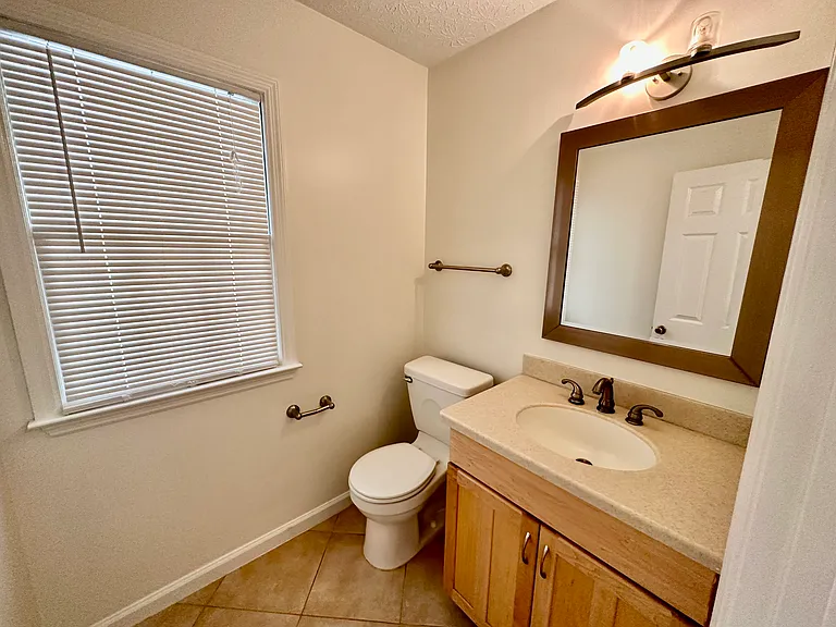 First floor half bathroom just off of the kitchen and living room.