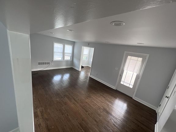 The living room has a door that connects to the balcony, and it also has a den area!