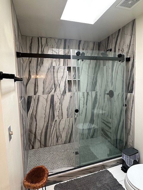 Master bath with natural sunlight via skylight