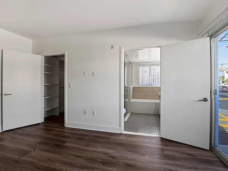 Bedroom, Walk-In Closet with Shelving, Bathroom, and Balcony