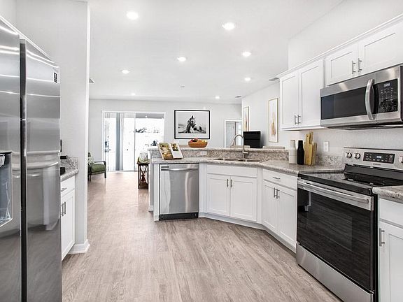 Enjoy a sunny kitchen, open to the gathering room - New home for sale in Auburndale, FL. Photo showc
