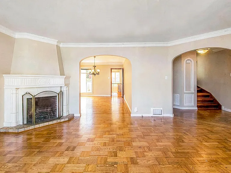 Living room on main level with open concept leading into the dining room. House will be delivered unfurnished.