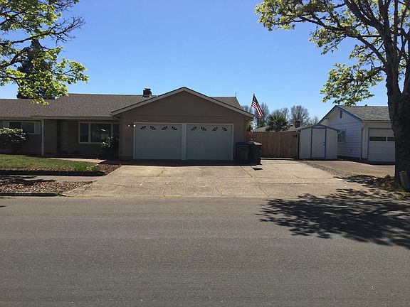 Drive through gate to RV pad on right of garage.