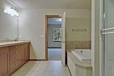 Grand master bath w/ 36' counters, full length mirror, custom lighting and fixtures, custom tile wor
