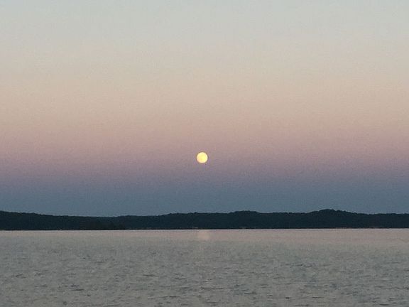 Moon rising over lake