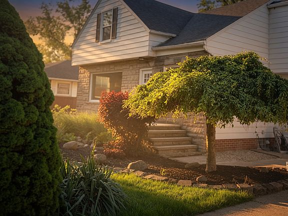 Beautiful front entrance with stone foundation, steps, and professional landscaping _ perfect curb appeal at golden hour.