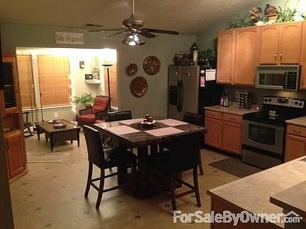 Looking from the family room
						:
						The open design and vaulted ceilings makes this home seem much larger.