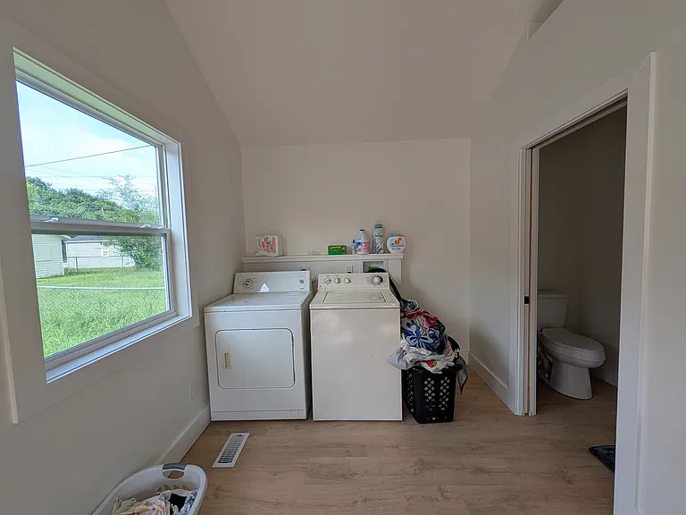 Laundry area by half bath and dining
