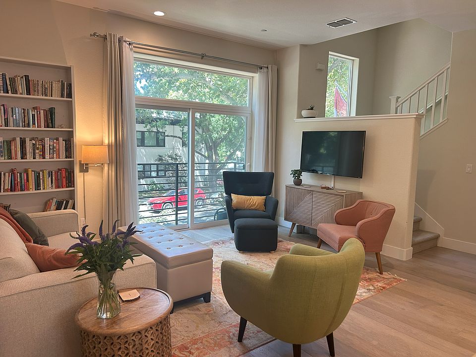 Living room, located on second floor, with view out to Midtown pedestrian life.