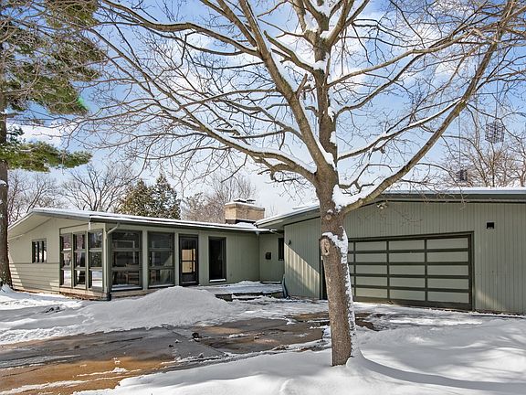 Exterior East Side of house, garage and sun room view