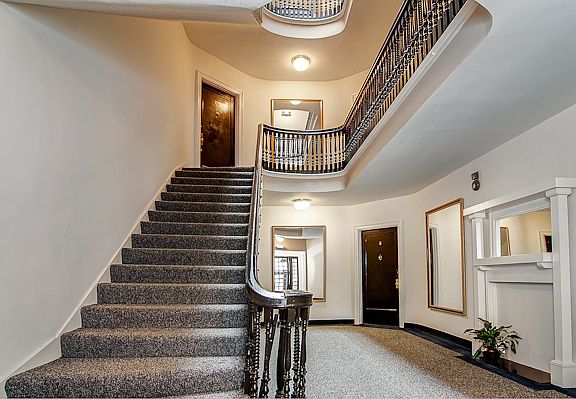 Gracious building foyer with beautiful period stairway.