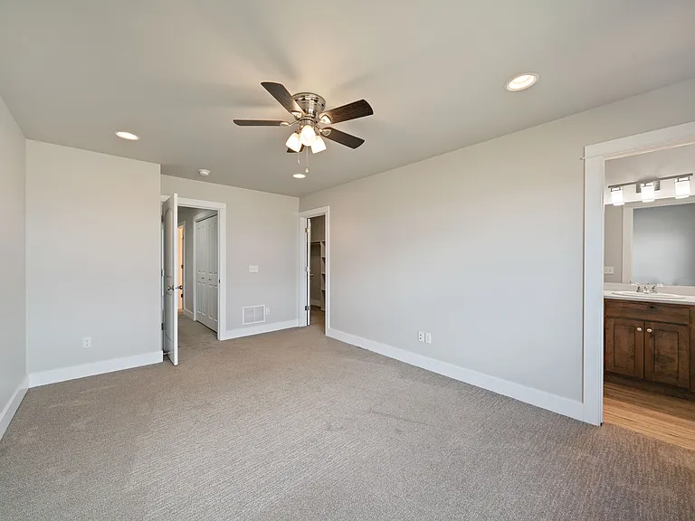 Large primary bedroom with spacious closet and attached bathroom