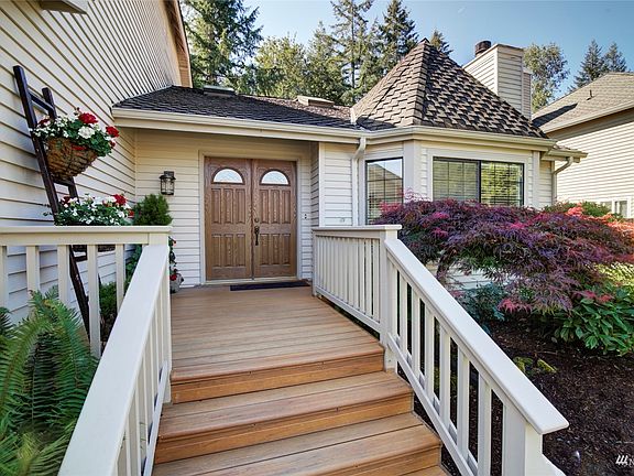 Charming double doors and wide front porch greet you >