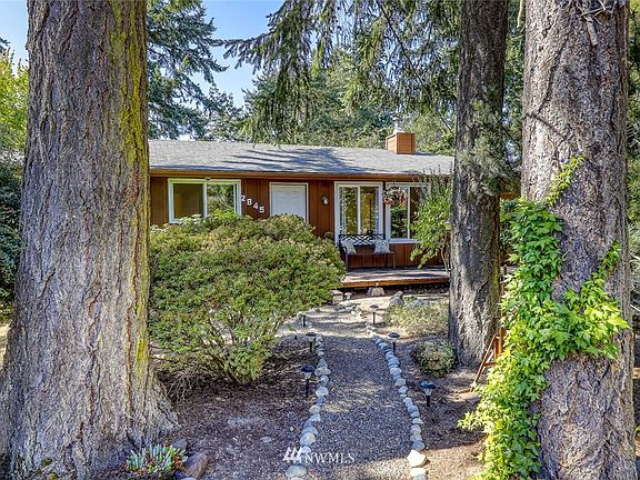 Walkway leads from parking area to front of home.