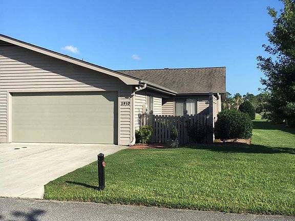 Street view of townhome with 1.5 car garage and enclosed courtyard