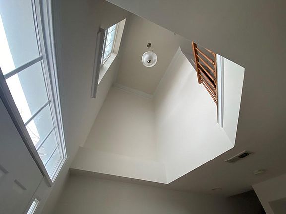 Beautiful gemometric ascending view to high ceiling looking up from foyer bring is plenty of natual light.