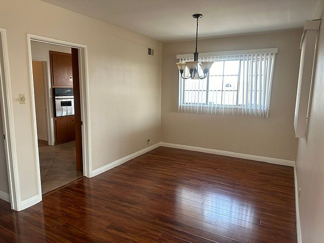 Spacious dining area next to the kitchen and living room with overhead lights
