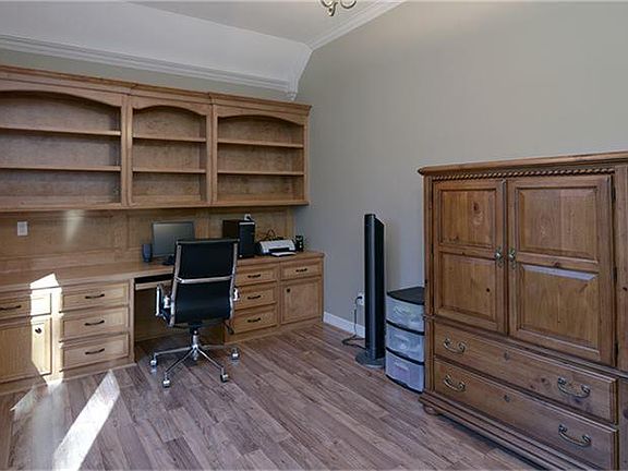  The study has some beautiful custom built-ins and wood floors.