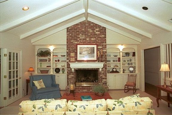 Large Great Room with vaulted ceiling, brick fireplace with gas logs.