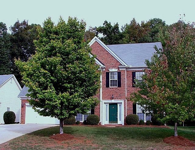 Front with wide driveway and two car garage